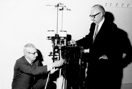 Photograph of Dean Campbell and Professor Shinn at the tie making machine on which the artificial artery was invented.
