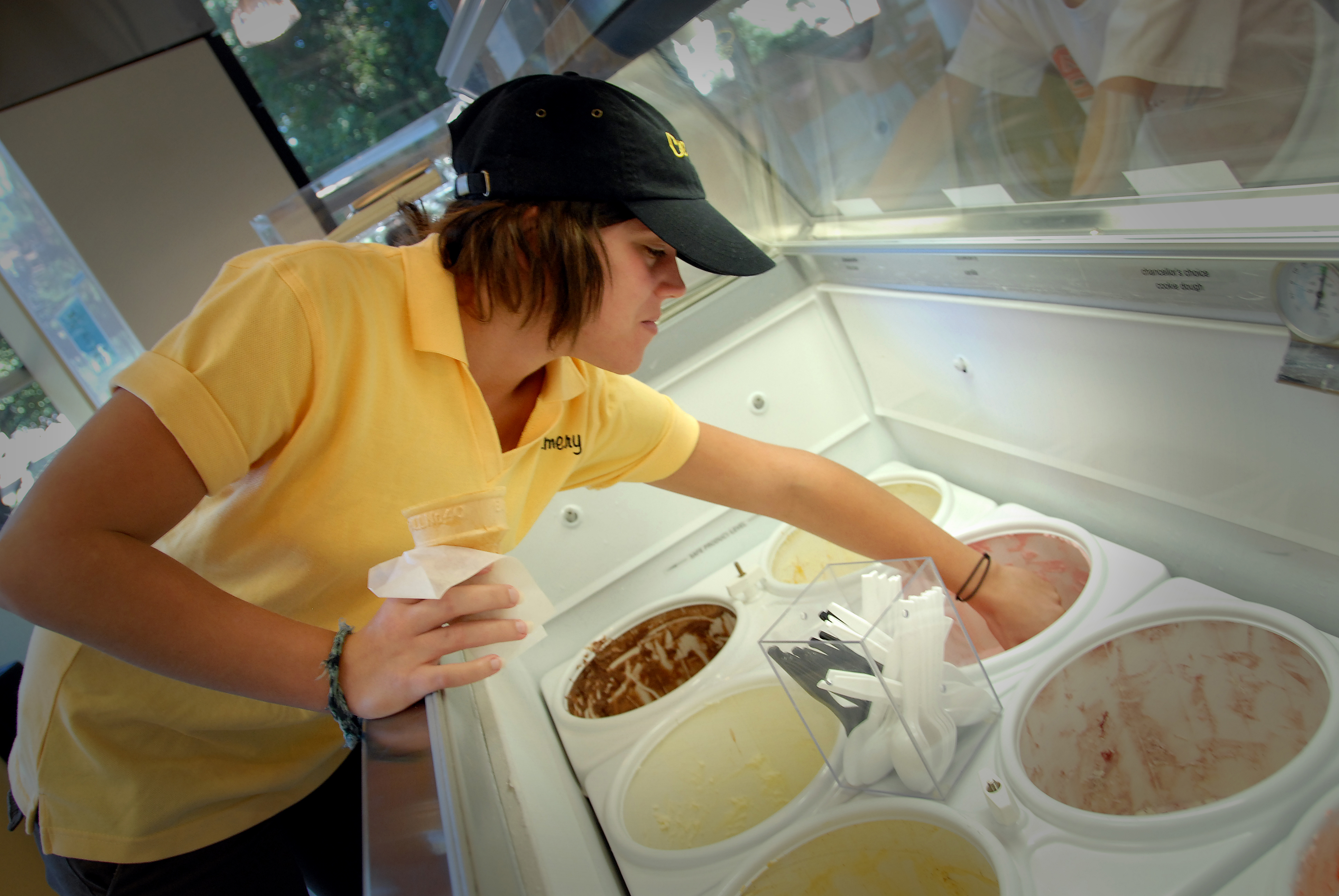 A student worker scoops ice cream for a patron at the Creamery at the D. H. Hill Jr. Library. 