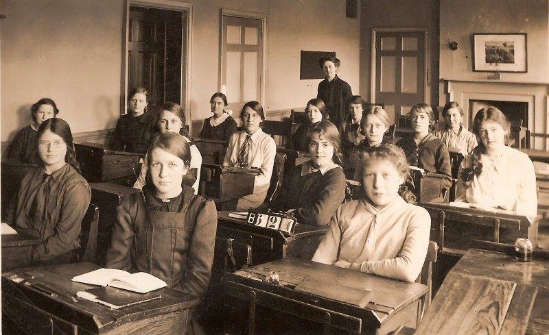 Classroom of women sitting at desks.