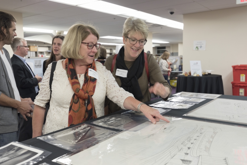 Friends of the Library members explore drawings from the Matthew Nowicki Papers at a recent open house event in Special Collections.